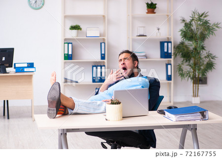 Young male employee during pandemic at workplace Young male employee during pandemic at workplace 72167755