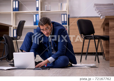 Young male businessman employee unhappy with his work 72167762