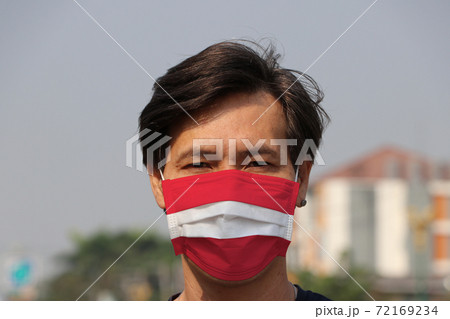 Austria flag on hygienic mask. Masked the man prevent germs. Austria flag on hygienic mask. Masked the man prevent germs. 72169234