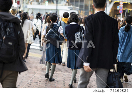 渋谷駅前を歩く制服の女子高生の後ろ姿の写真素材