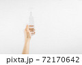 Bottle with antibacterial antiseptic gel in hand on white background 72170642