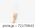 Bottle with antibacterial antiseptic gel in hand on white background 72170643