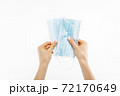 Close up of hand with mask, Surgical mask, on isolated white background, coronavirus disease, COVID-19 72170649