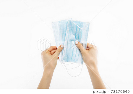 Close up of hand with mask, Surgical mask, on isolated white background, coronavirus disease, COVID-19 72170649