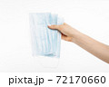 Close up of hand with antiviral mask, Surgical mask, on isolated white background, coronavirus disease 72170660