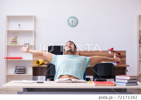 Young male student preparing for exam at home 72171162
