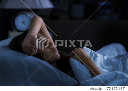 Depressed young woman lying in bed cannot sleep from insomnia 72172187