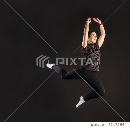 Fitness jumped. Engaged in sports on a black background Beautiful with a beautiful smile Fitness jumped. Engaged in sports on a black background Beautiful with a beautiful smile 72172944