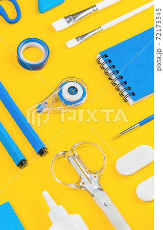 Assorted office and school white and blue stationery on yellow 72173545