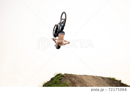 BMX rider in action at bike sport competition outdoors on sunset BMX rider in action at bike sport competition outdoors on sunset 72175068