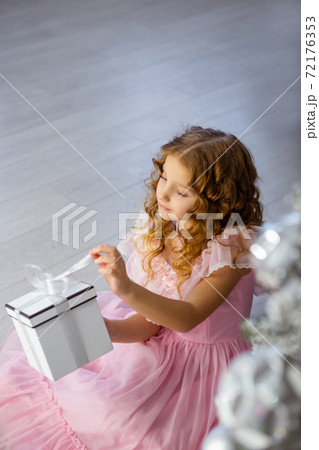 Happy girl in holding the opened present box. 72176353
