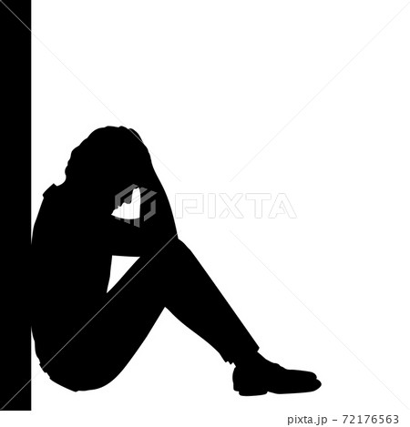 Silhouette of pensive man sitting by the wall 72176563