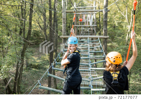 Man and woman in a rope park Man and woman in a rope park 72177077
