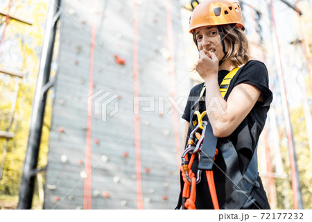 Scared woman near the climbing wall Scared woman near the climbing wall 72177232