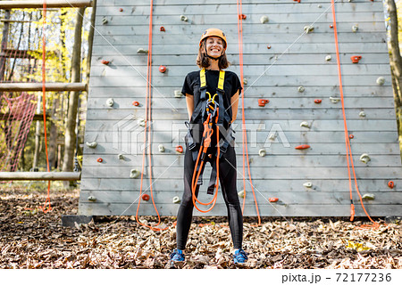 Well equipped woman near the climbing wall 72177236