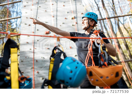 Well equipped man near the climbing wall outdoors 72177530