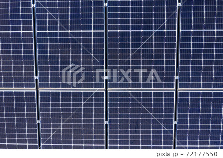 Blue solar panels in a grid pattern on a residential roof 72177550