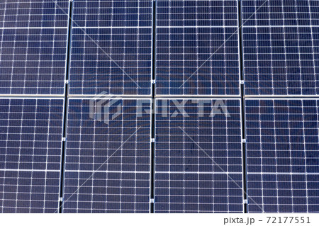 Blue solar panels in a grid pattern on a residential roof Blue solar panels in a grid pattern on a residential roof 72177551