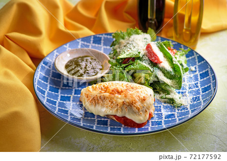 Grilled chicken fillet with fresh salad - arugula and tomato. Ketogenic food. Healthy lunch. 72177592
