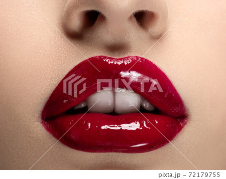 Beautiful woman lips with red lipstick Beautiful woman lips with red lipstick 72179755