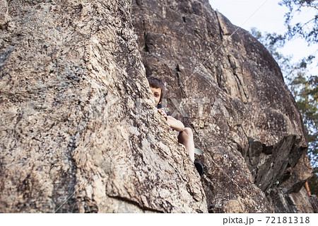 cute teen kid climbing on rock with insurance, lifestyle sport people concept 72181318