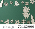 2021 year wooden symbol of bull or ox in chinese calendar. Christmas and New Year flat lay composition. Border made of Xmas decorations up and down on green background. Top view, copy space 72182999