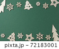 Christmas and New Year flat lay composition. Border made of wooden Xmas decorations up and down on green background. Greeting card concept, winter holiday wishes template. Top view, copy space 72183001