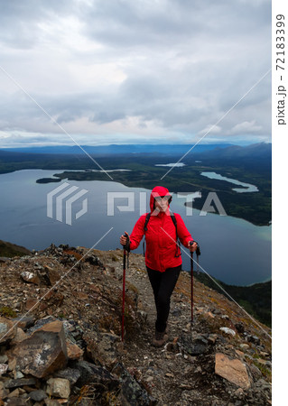 Girl Hiking on top of a Mountain Peak Girl Hiking on top of a Mountain Peak 72183399