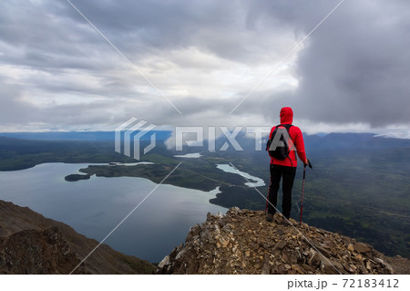 Girl Hiking on top of a Mountain Peak 72183412