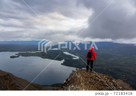 Girl Hiking on top of a Mountain Peak Girl Hiking on top of a Mountain Peak 72183416