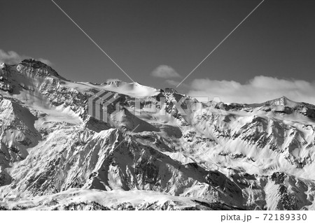 View on snowy sunlight mountains and glacier in nice sunny evening. Caucasus Mountains at winter. Svaneti region of Georgia. Black and white toned landscape. View on snowy sunlight mountains and glacier in nice sunny evening. Caucasus Mountains at winter. Svaneti region of Georgia. Black and white toned landscape. 72189330
