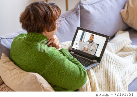 Photo of a sick senior woman at home during online cousultation with a doctor. Photo of a sick senior woman at home during online cousultation with a doctor. 72191551