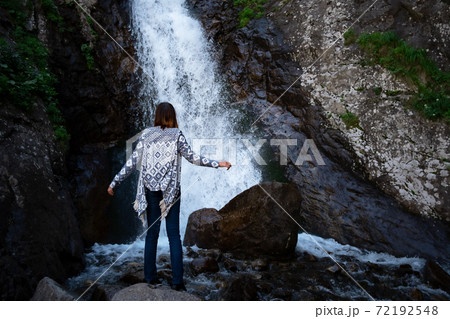 Young happy woman enjoing the summer waterfall. 72192548