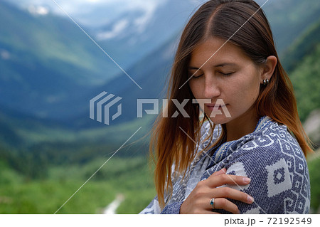 Stylish female hipster walking on top of mountains. 72192549