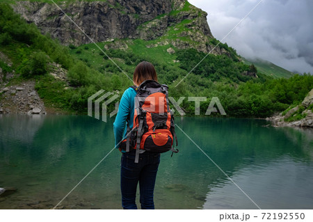 Traveler look at the mountain lake. Travel and active life concept. 72192550