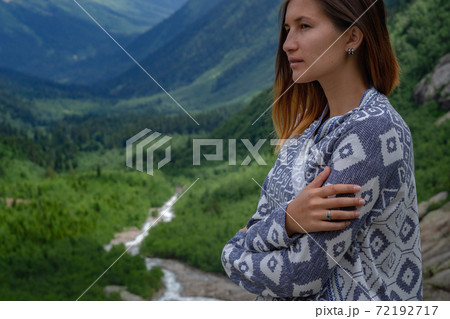 Stylish female hipster walking on top of mountains. Stylish female hipster walking on top of mountains. 72192717