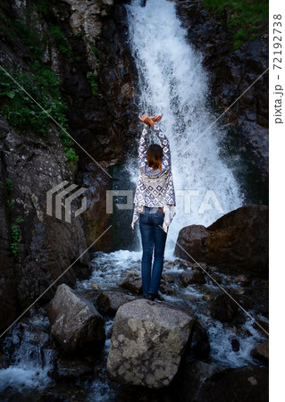Young happy woman enjoing the summer waterfall. Young happy woman enjoing the summer waterfall. 72192738