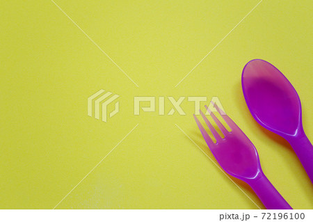 Plastic spoon and fork placed on a bright background. 72196100