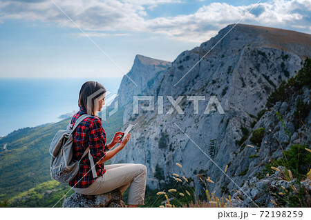 woman hiker enjoy the view at sunset mountain peak cliff 72198259