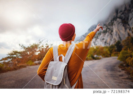 Outdoor fashion photo of young beautiful lady surrounded autumn forest in mountains 72198374