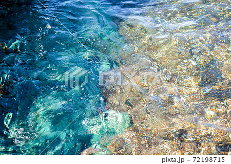 Underwater sea stones, surface with ripples and waves, beautiful pattern transparent clear water Underwater sea stones, surface with ripples and waves, beautiful pattern transparent clear water 72198715
