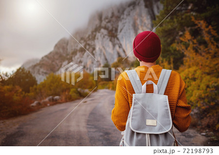 Outdoor fashion photo of young beautiful lady surrounded autumn forest in mountains 72198793