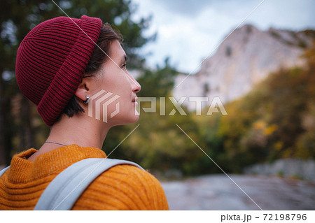 Outdoor fashion photo of young beautiful lady surrounded autumn forest in mountains 72198796