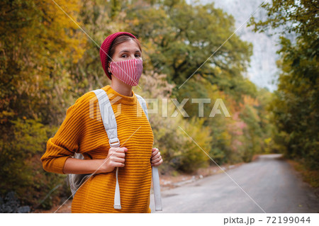 Outdoor fashion photo of young beautiful lady surrounded autumn forest in mountains 72199044