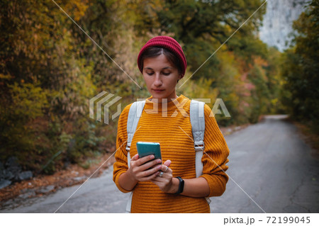 Outdoor fashion photo of young beautiful lady surrounded autumn forest in mountains 72199045