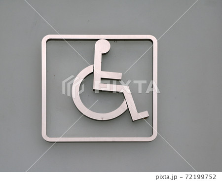 Handicapped mark on the door in front of the Bathroom disabled.  72199752
