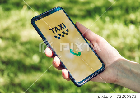 Smartphone with app for calling a taxi in hand. 72200873