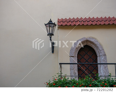 entrance with rustic door and a wall lantern 72201202