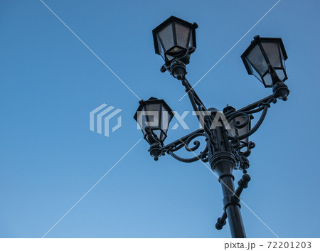 Old cast iron street lamp with four lamps Old cast iron street lamp with four lamps 72201203