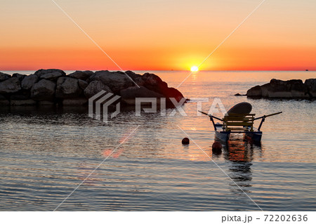 Pedalo moored in the sea during the sunrise 72202636